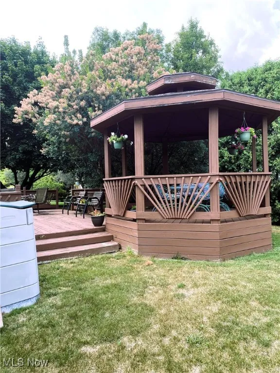Deck featuring a lawn and a gazebo