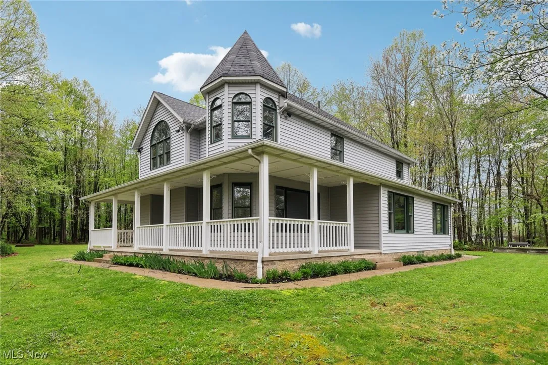 Victorian home with a porch and a front yard