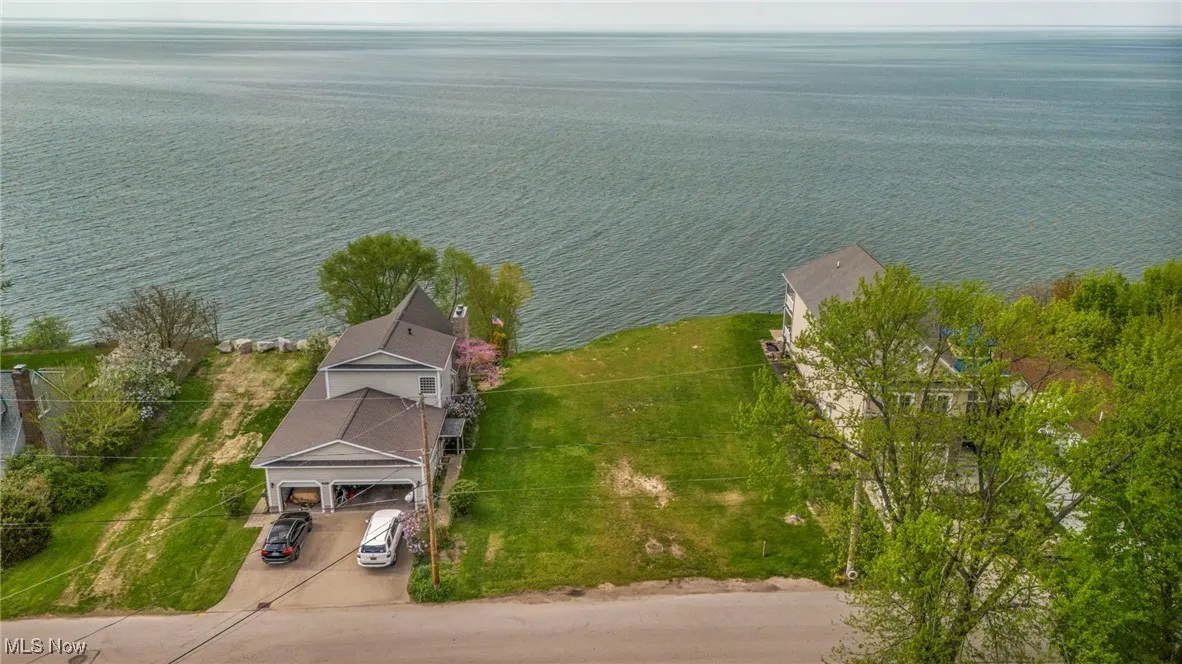 Birds eye view of property with a water view