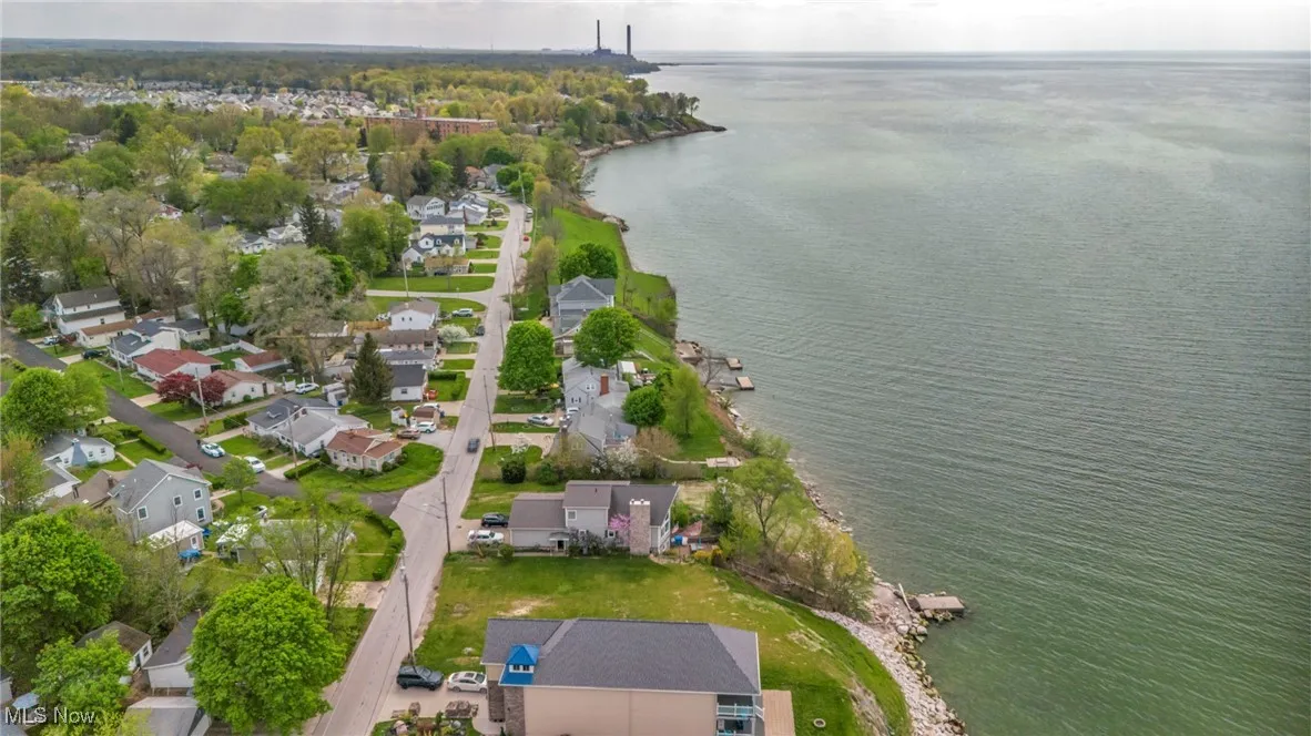 Birds eye view of property with a water view and a residential view