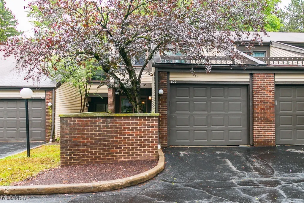 Garage featuring asphalt driveway