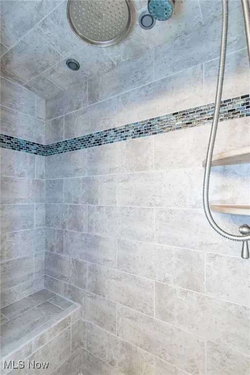 Bathroom featuring a tile shower