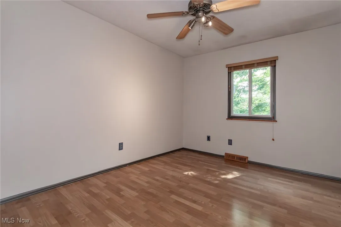 Spare room featuring light wood-type flooring and a ceiling fan