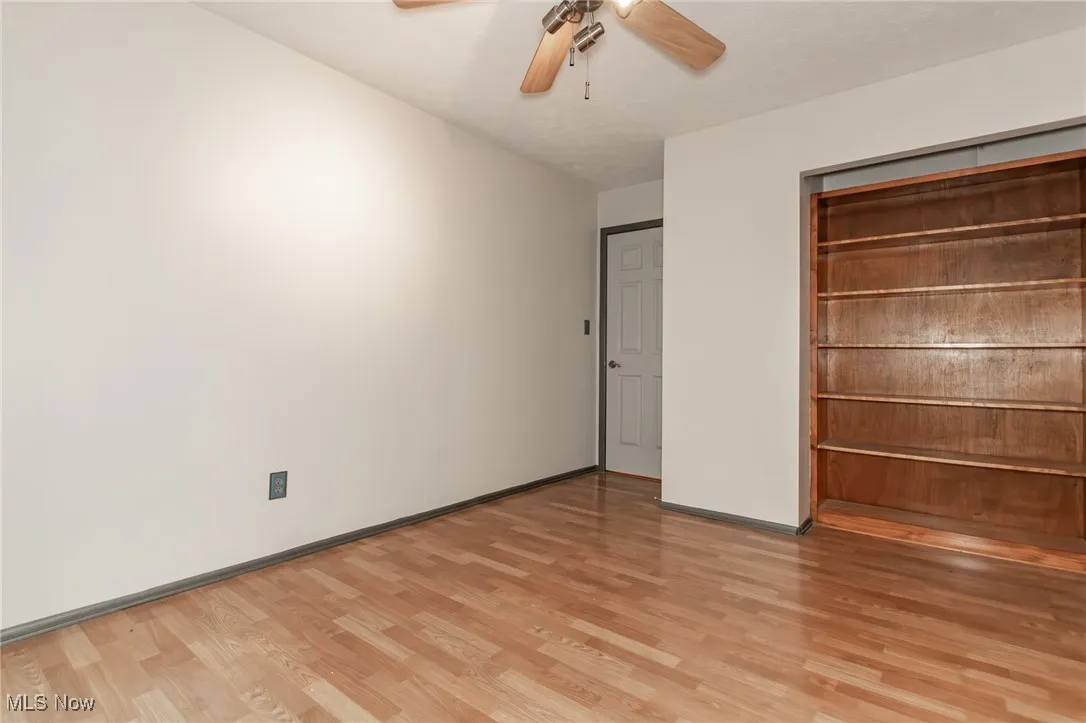 Unfurnished bedroom with light wood-type flooring and a ceiling fan
