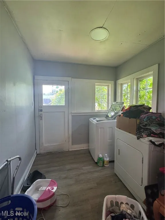 Washroom featuring separate washer and dryer and wood finished floors