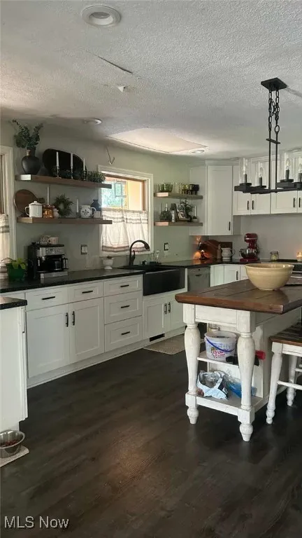 Farm style kitchen with farm sink, wood look vinyl plank flooring
