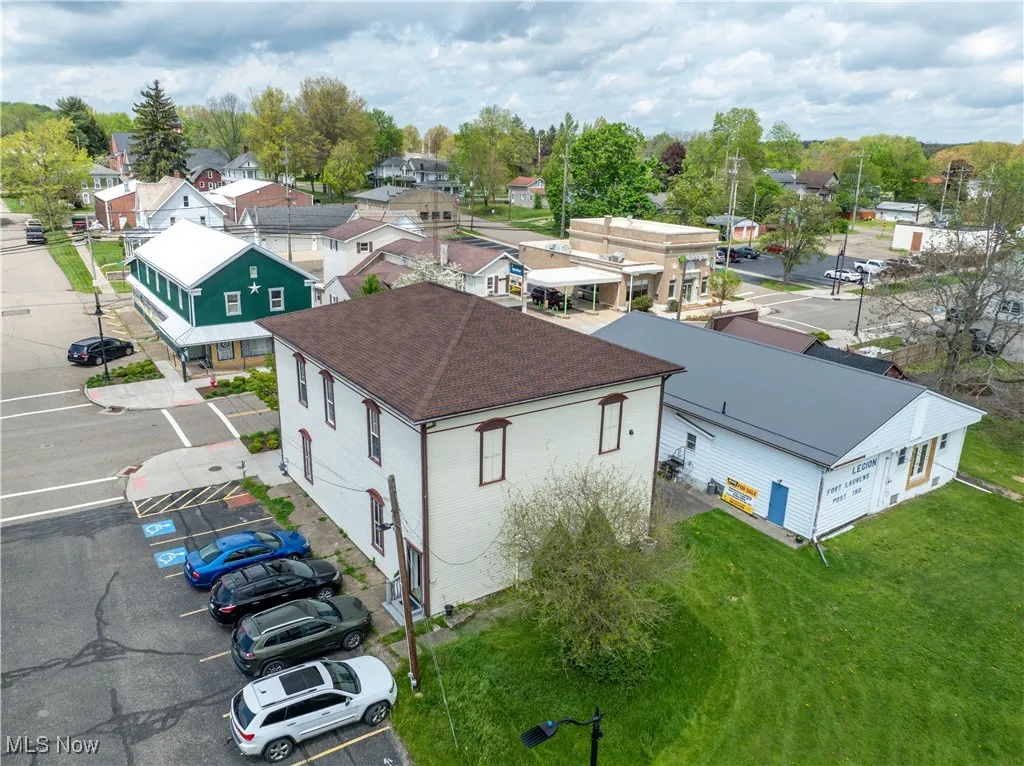 Aerial view of side/back of building with parking area