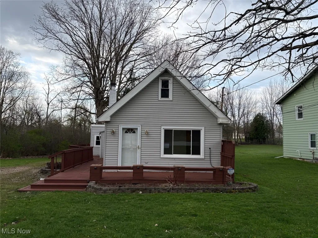 Front view of the property with a deck
