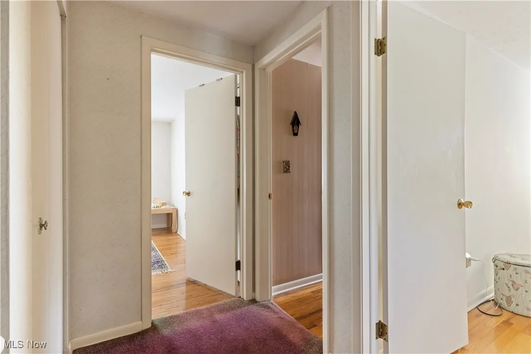 Corridor featuring wood finished floors