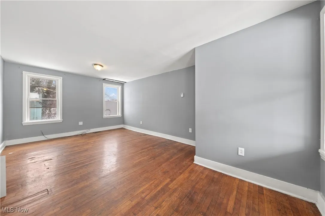 Unfurnished room (Back Unit) featuring baseboards and hardwood / wood-style flooring