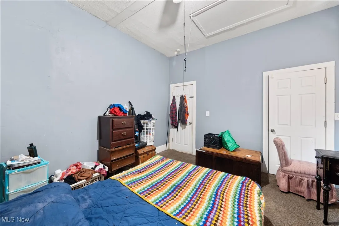 (down unit) Bedroom with carpet flooring and ceiling fan