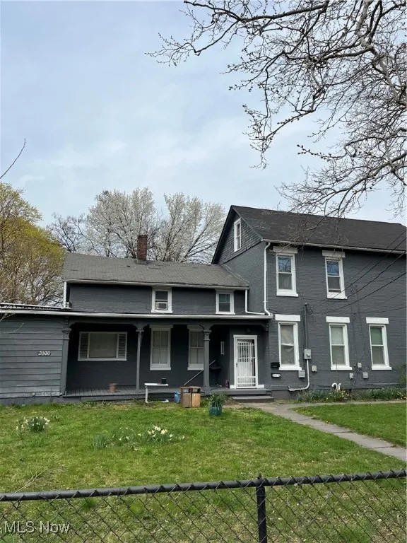 View of front of property with a chimney and covered porch
