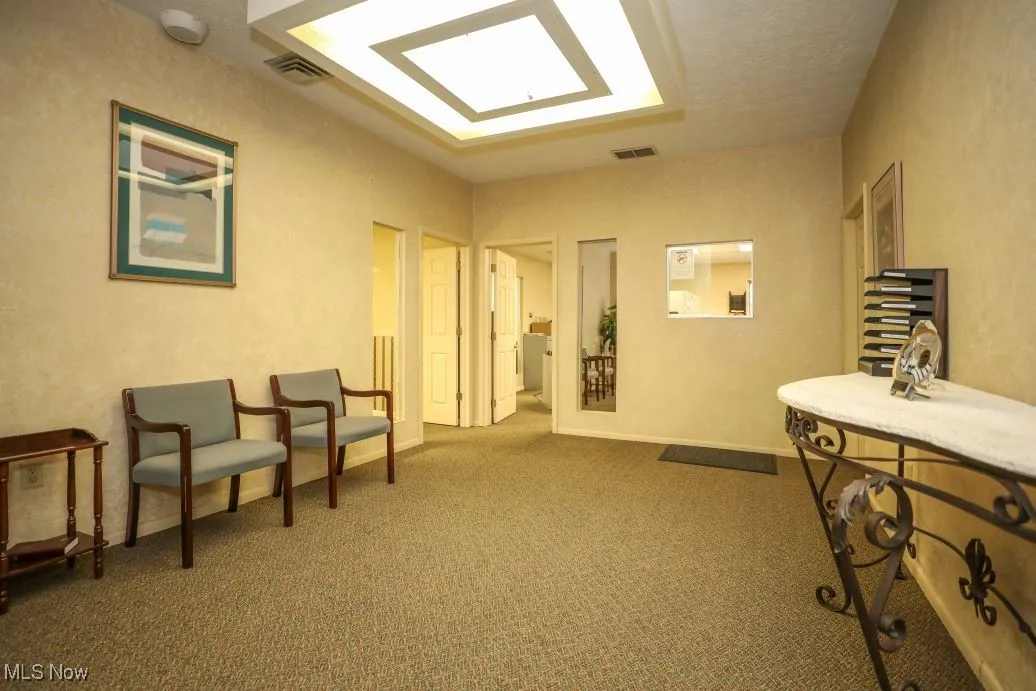 Living area with carpet floors and baseboards