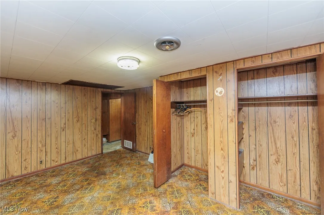 Basement featuring wooden walls