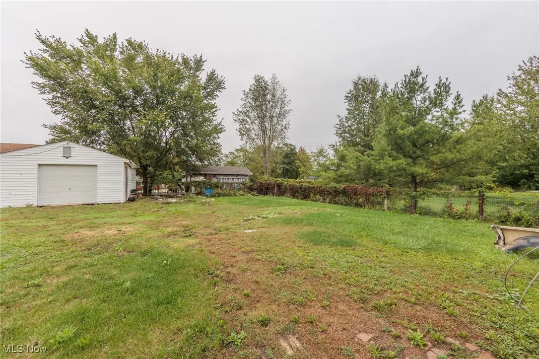 View of yard with an outbuilding and a garage