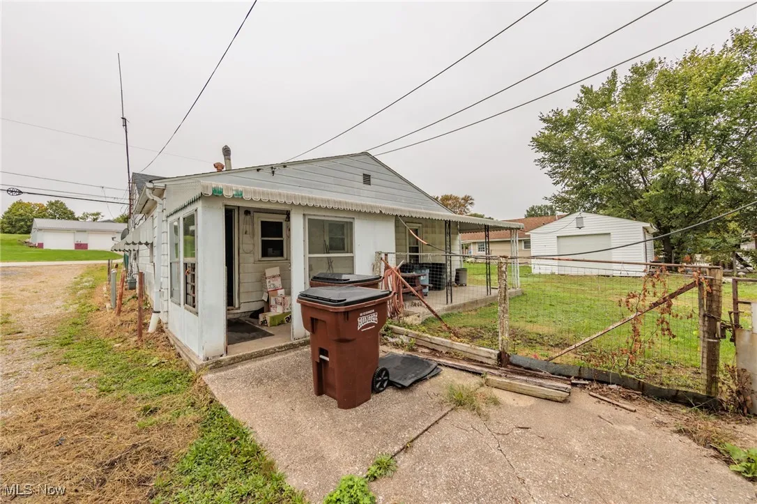 Rear view of property with a lawn