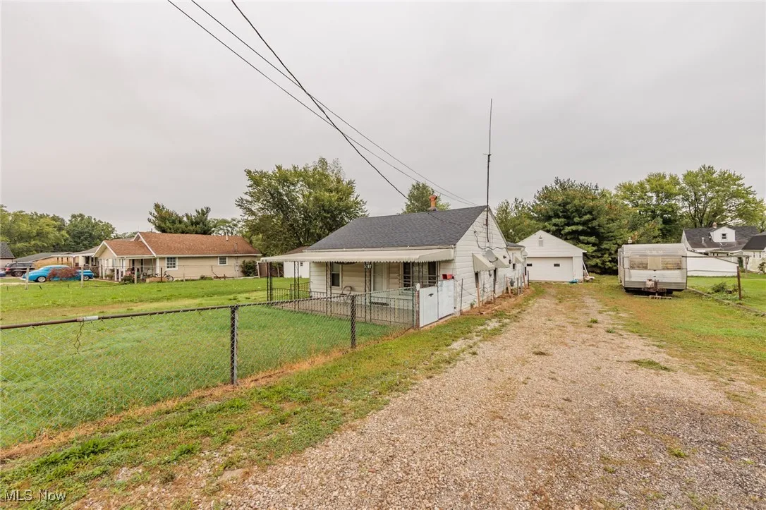 View of side of home with a yard