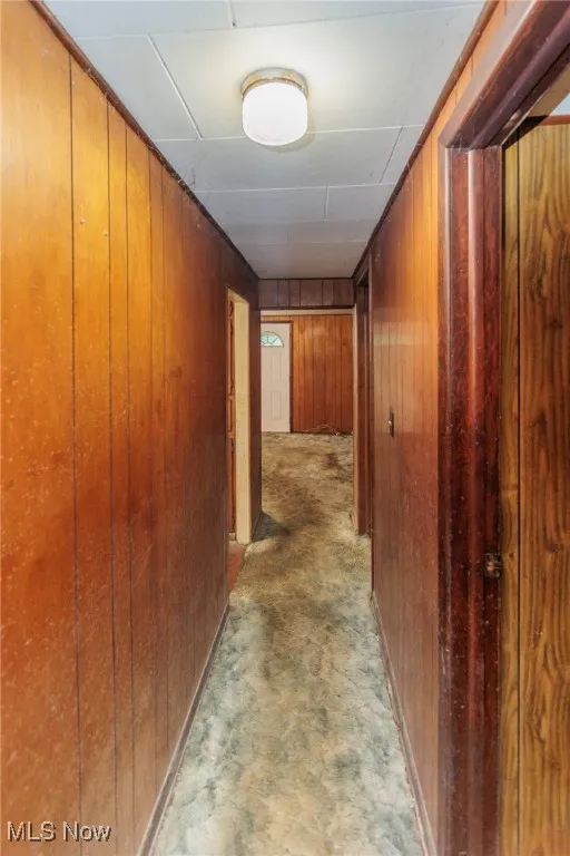 Hallway with wood walls