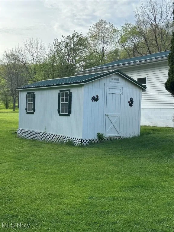 View of outbuilding with an outdoor structure