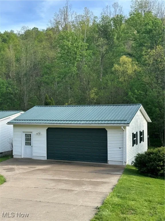 Detached garage featuring a wooded view