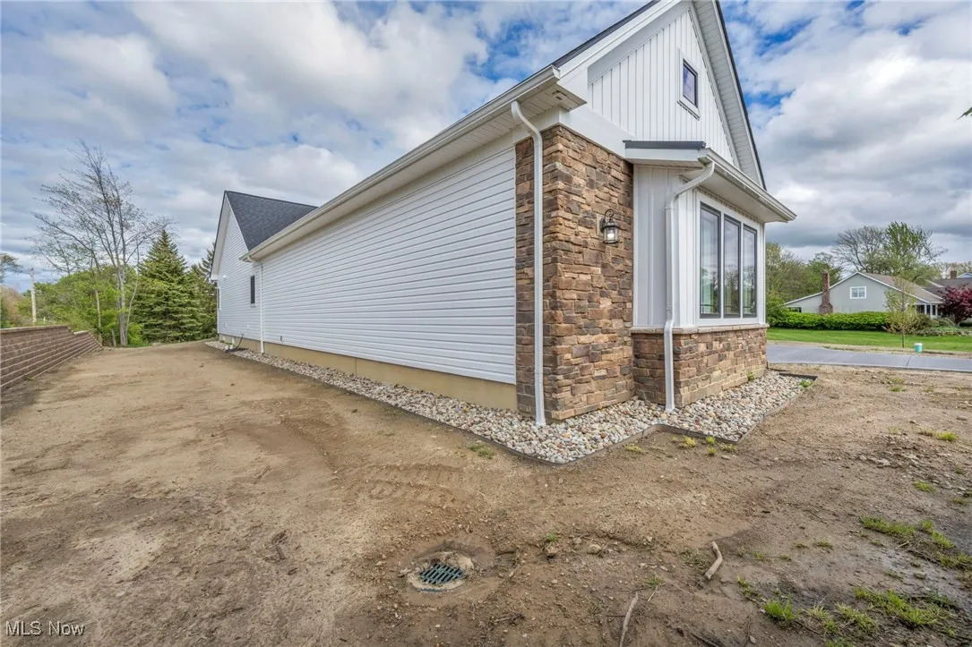 View of home's exterior featuring stone siding and board and batten siding