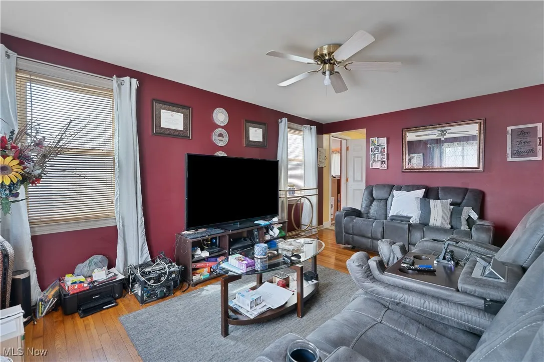 Living area featuring a ceiling fan, plenty of natural light, and hardwood / wood-style floors