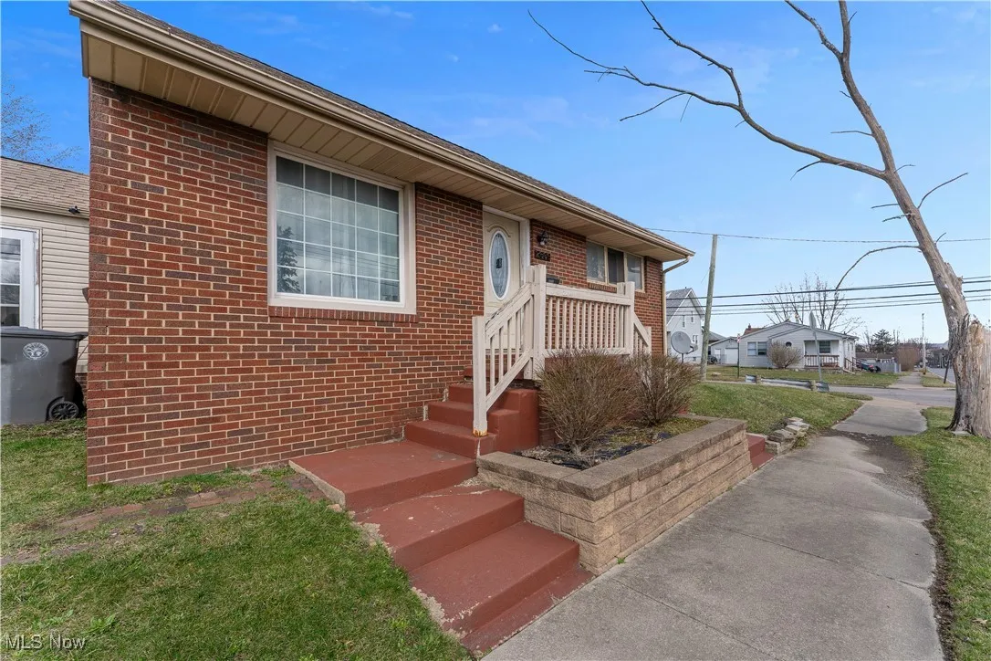 View of front of house featuring brick siding and a residential view