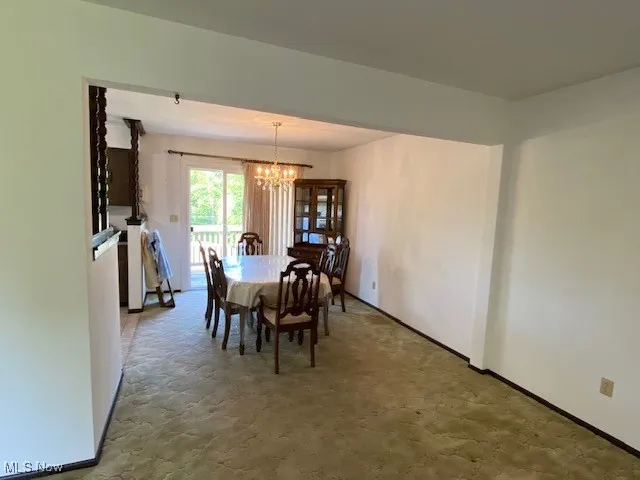 Dining room with a chandelier and baseboards