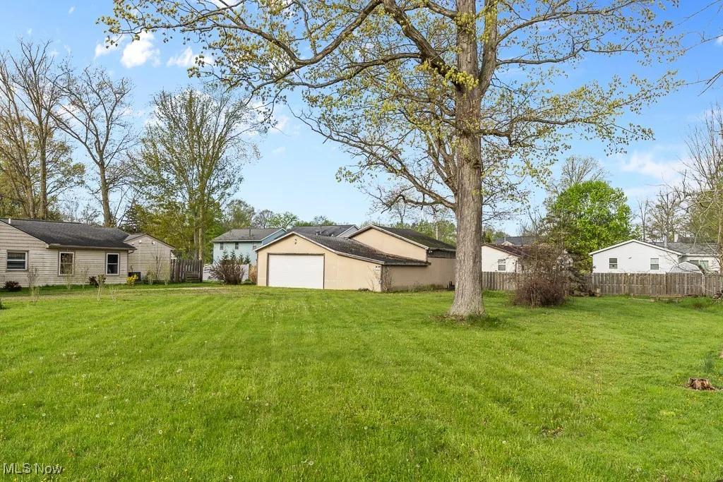 View of yard with a residential view and a detached garage