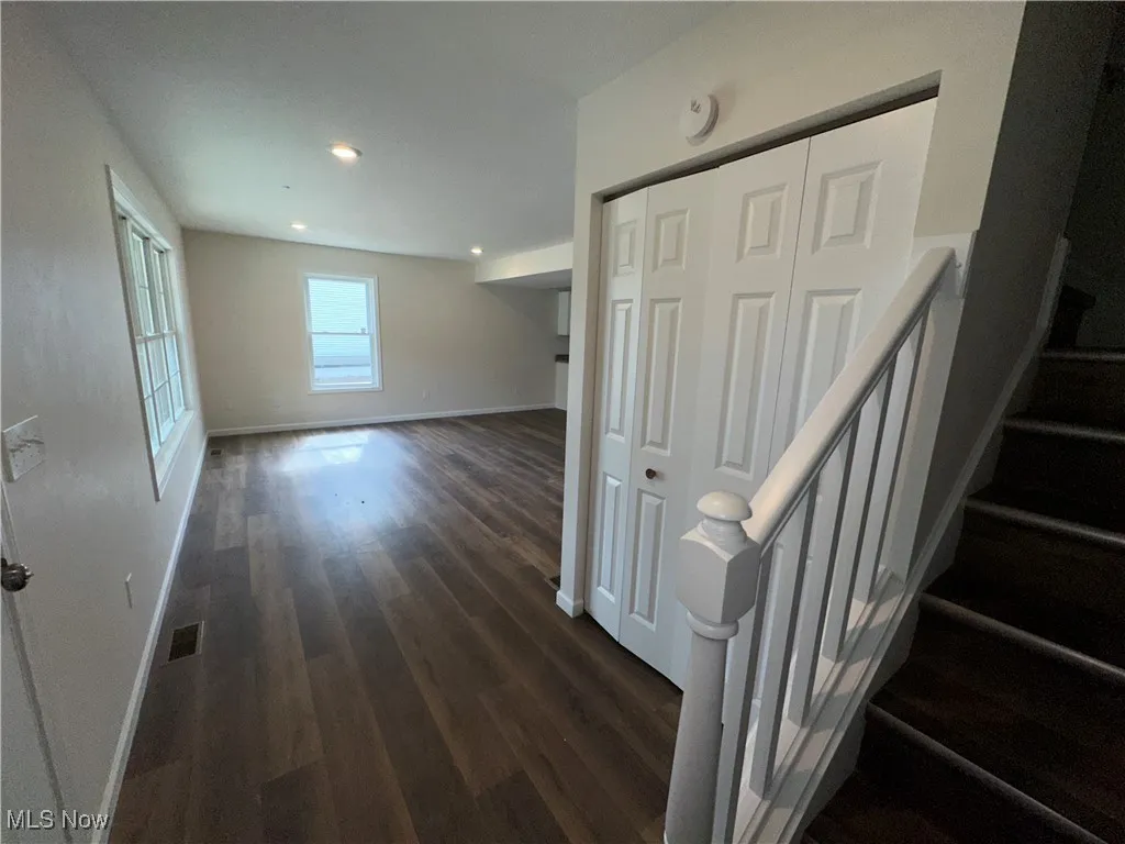 Stairs featuring LVT floors, baseboards, and recessed lighting