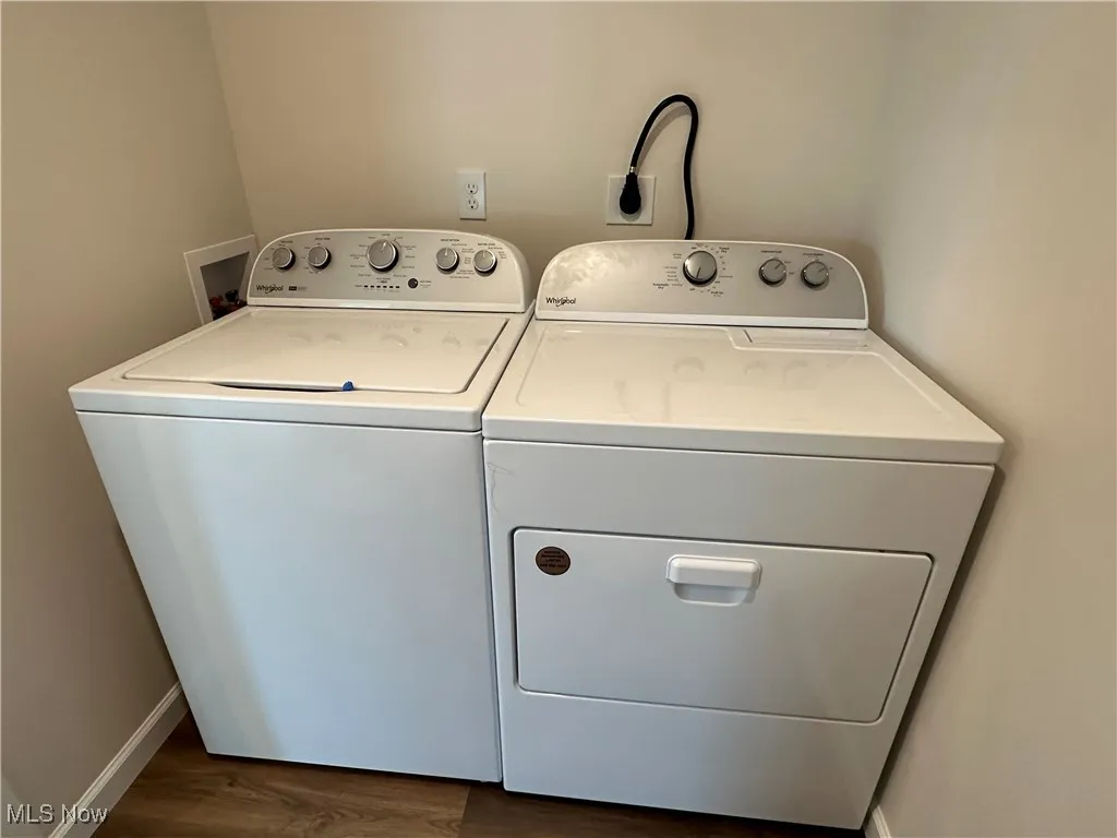 Laundry area with independent washer and dryer and dark LVT flooring