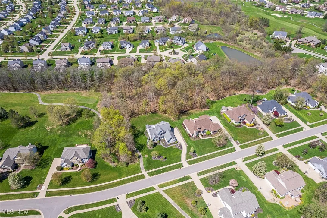Aerial overview of property's location with nearby suburban area and a large body of water