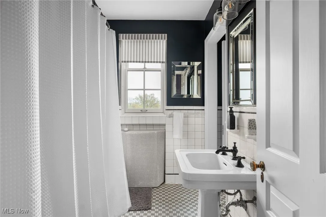 Bathroom with radiator and tile walls