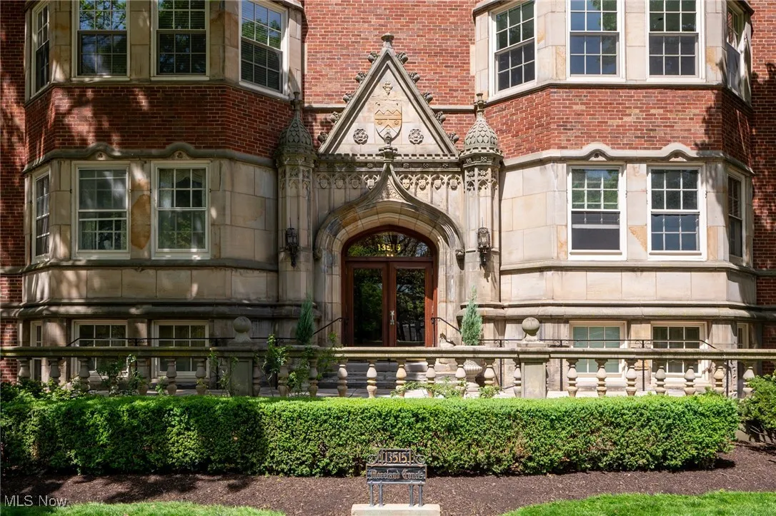 Entrance to property with stone siding, brick siding, and french doors