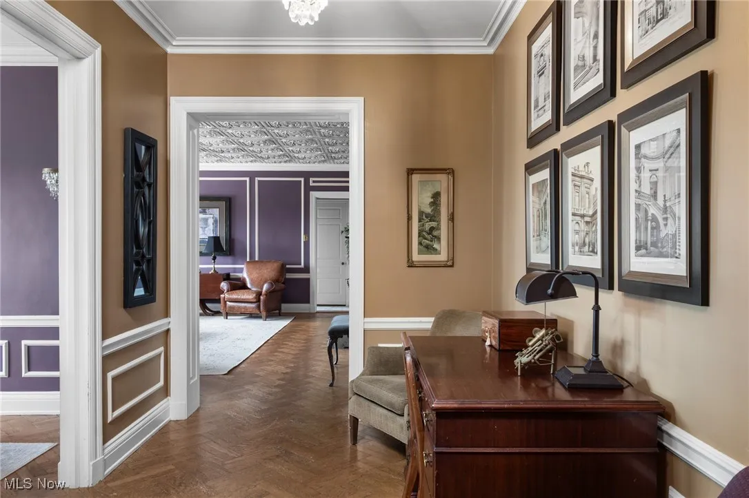 Corridor featuring crown molding and baseboards