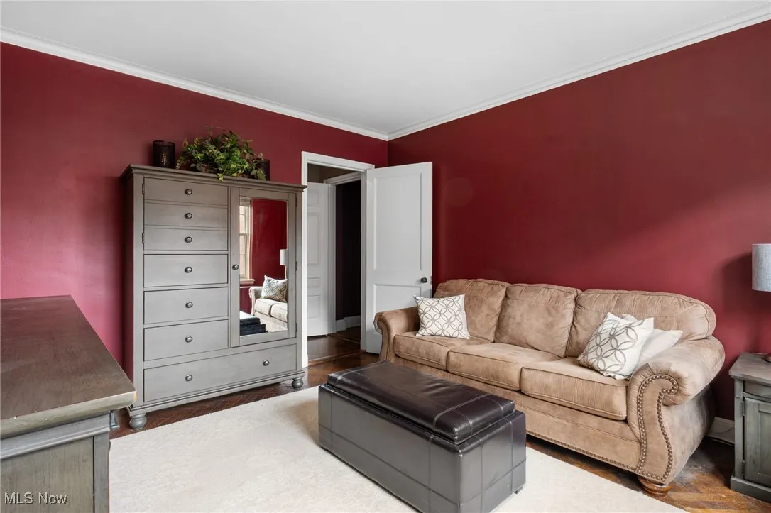 Living room featuring wood finished floors and ornamental molding