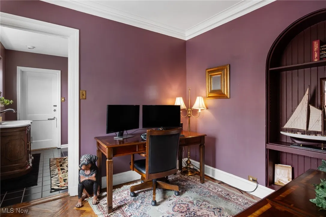 Home office featuring baseboards, ornamental molding, and a sink