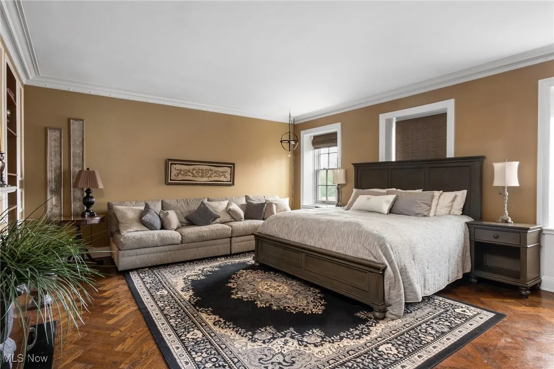 Bedroom with crown molding and baseboards