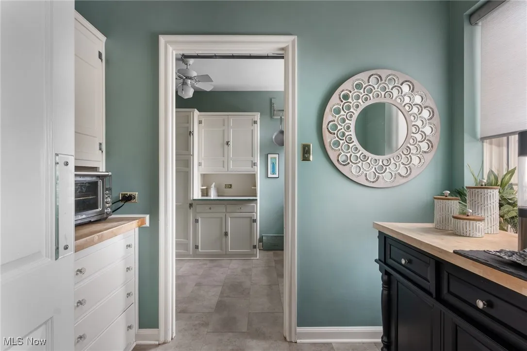 Bathroom with baseboards, vanity, and a ceiling fan