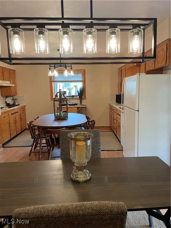 Dining room featuring light wood-style flooring and baseboards