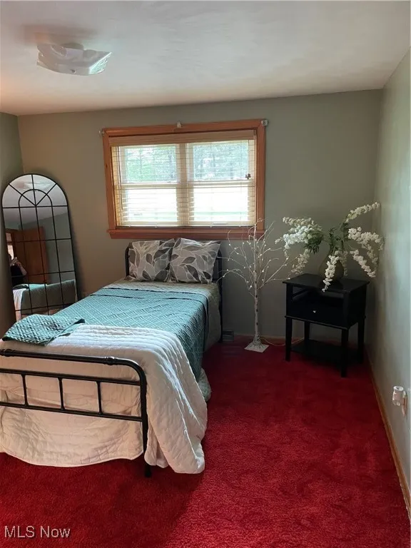Carpeted bedroom featuring baseboards