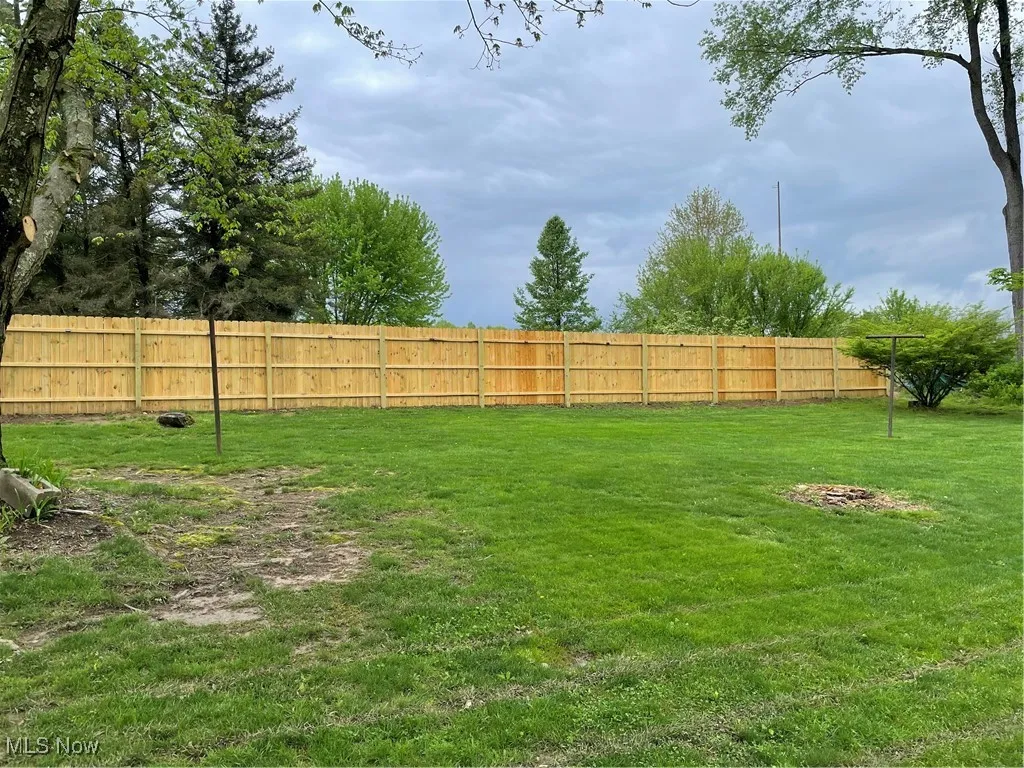 New Wood fence at back of property with solar lights attached