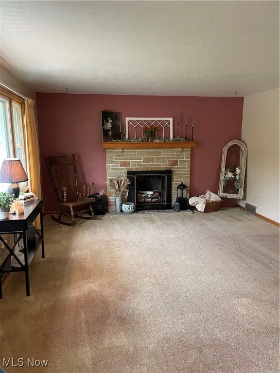 Living room featuring carpet flooring and a fireplace