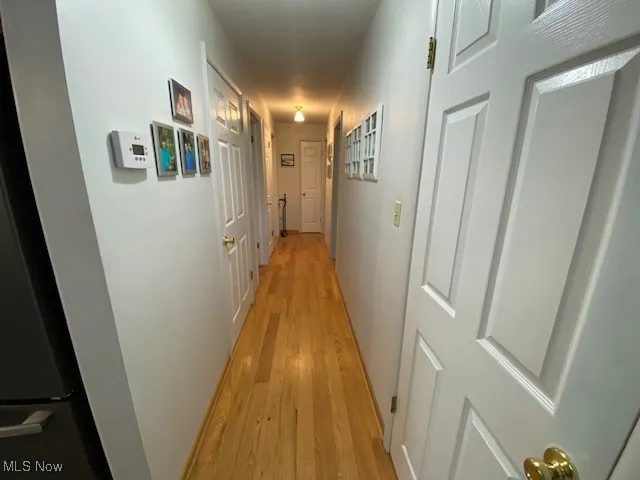 Hall featuring light wood finished floors
