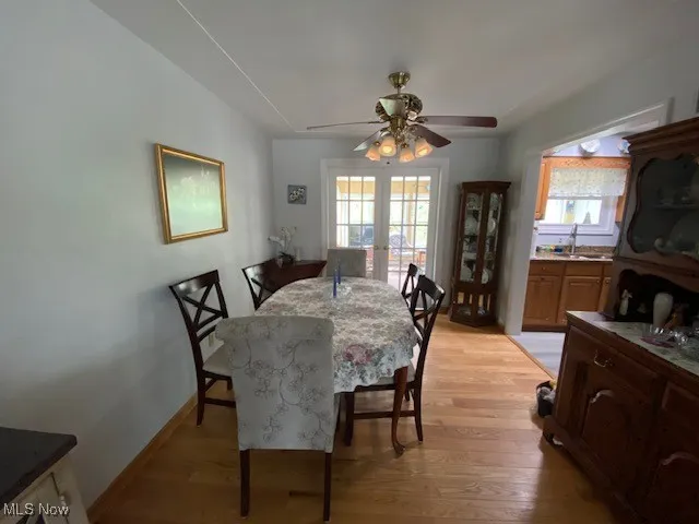 Dining area with light wood finished floors, ceiling fan, and plenty of natural light