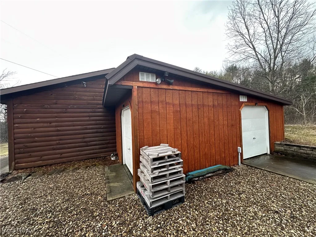 View of outdoor shed with a garage door