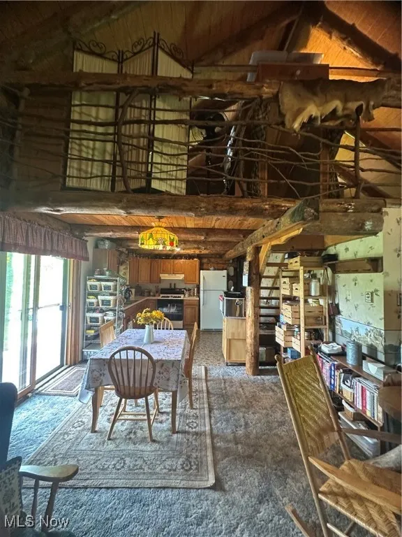 dining area featuring high vaulted ceiling