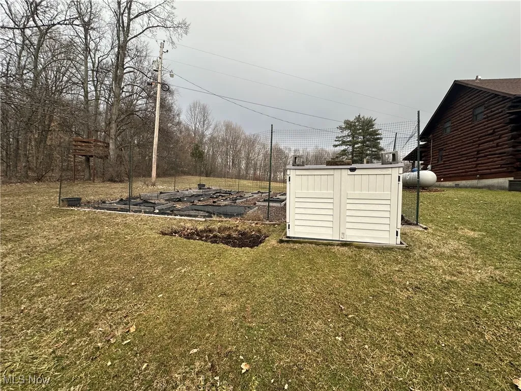 View of garden yard featuring a compost  structure