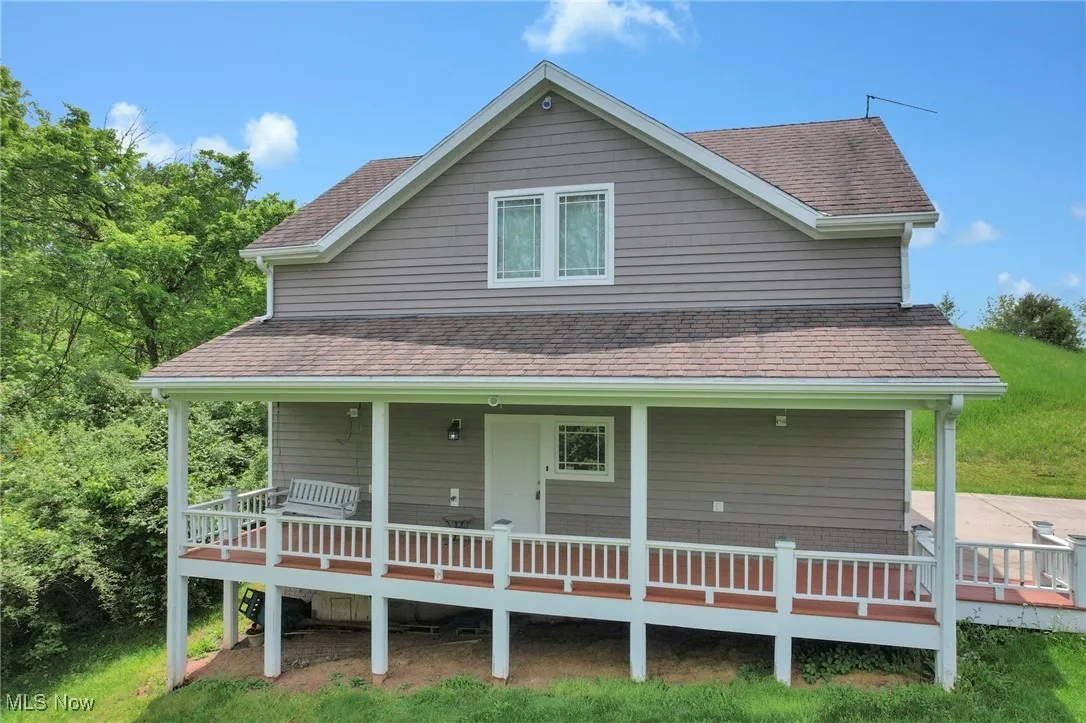 View of front facade featuring roof with shingles