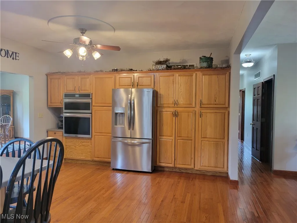 Kitchen with hardwood flooring and abundance of oak cabinetry